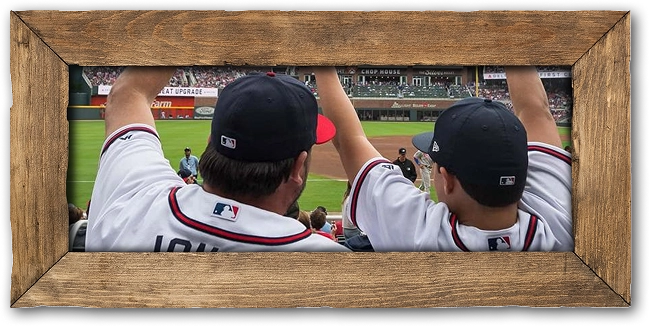 A framed photo of two people at a baseball game